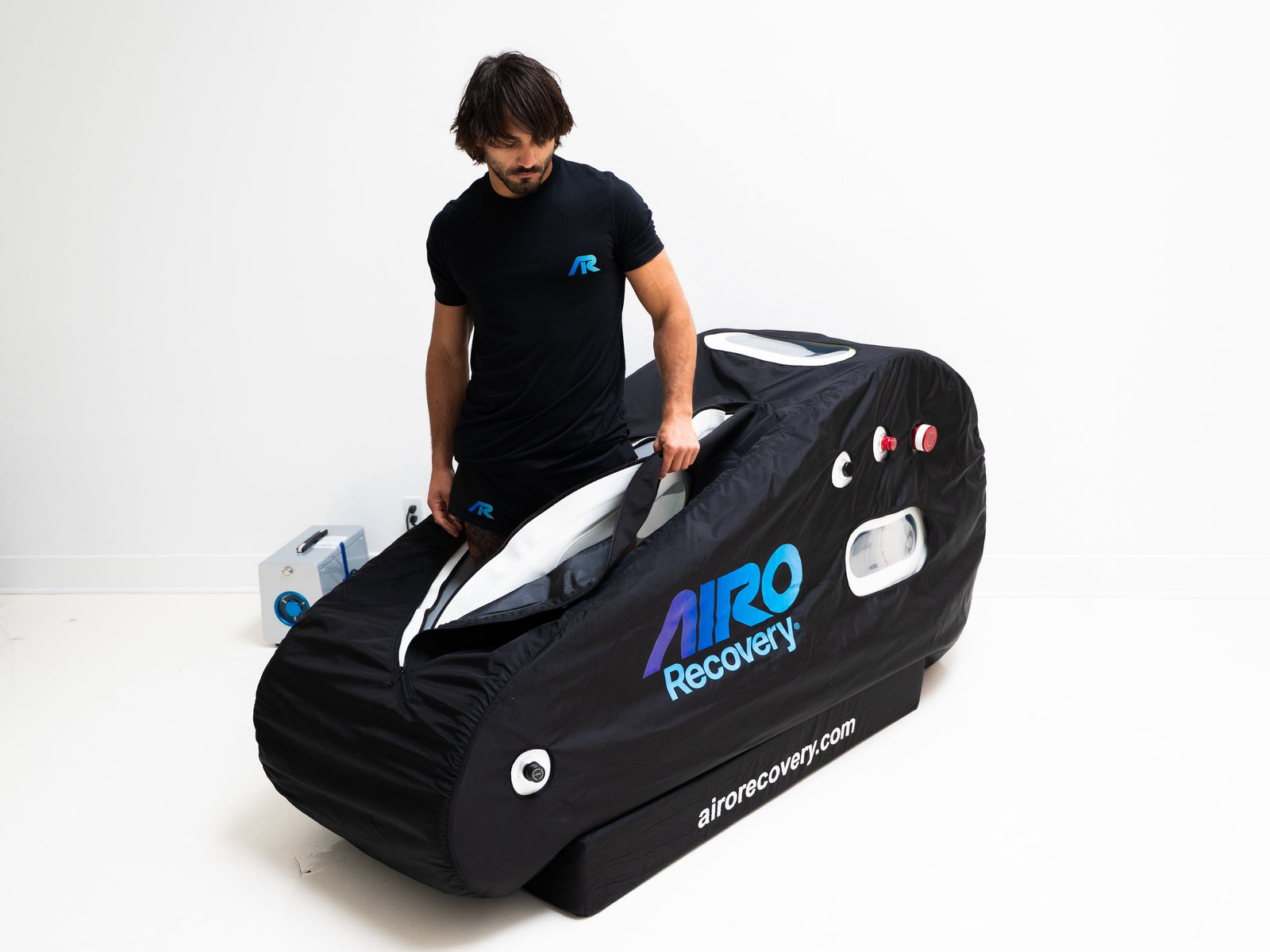 A row of sleek hyperbaric oxygen therapy chambers from Airo Recovery lined up side by side. The hyperbaric chambers display advanced technology for oxygen therapy treatments, suitable for various settings.